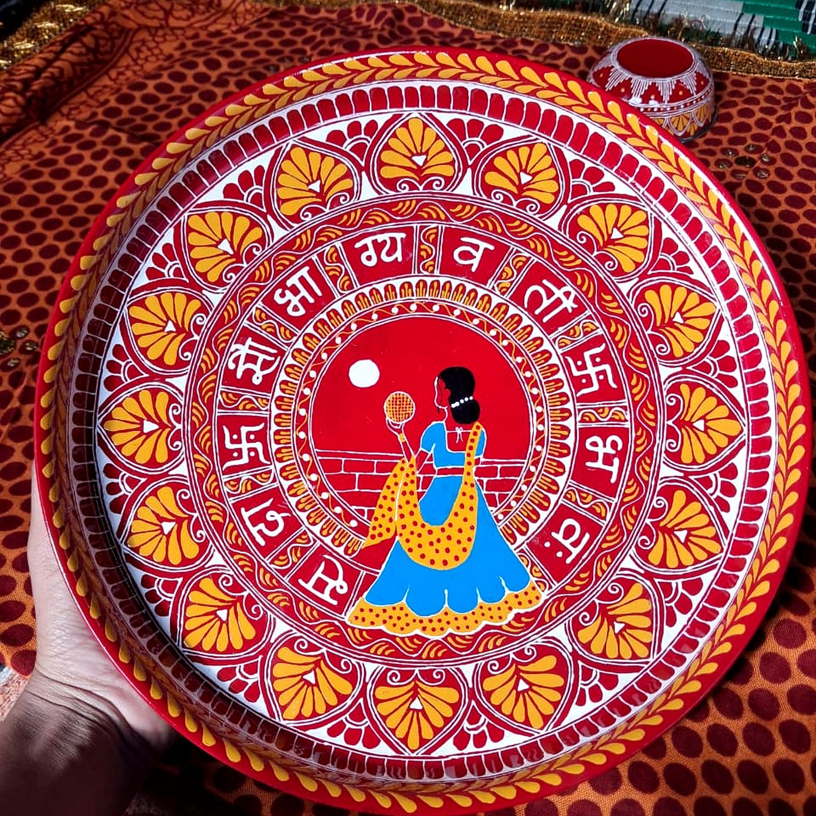 Close-up of hand-decorated Aipan-inspired thali artwork